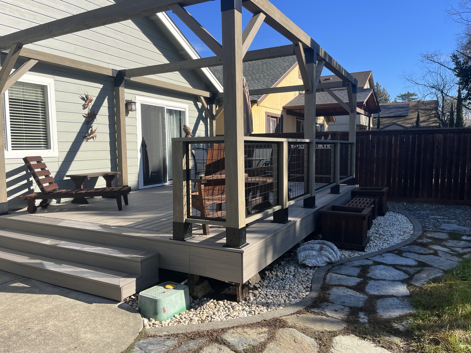 Composite deck under a covered timber-frame pergola with cable railing — Soulié Construction, Sonoma County