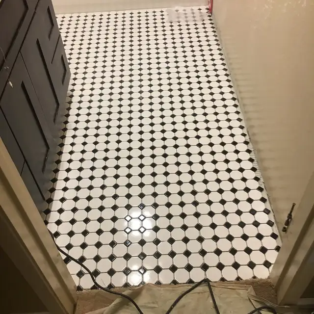 Black and white octagon mosaic tile floor in a Healdsburg bathroom remodel with dark wood vanity