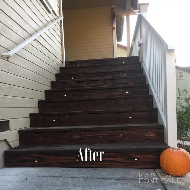 Rebuilt exterior entry staircase in Healdsburg with dark wood treads, riser lights, and painted railing