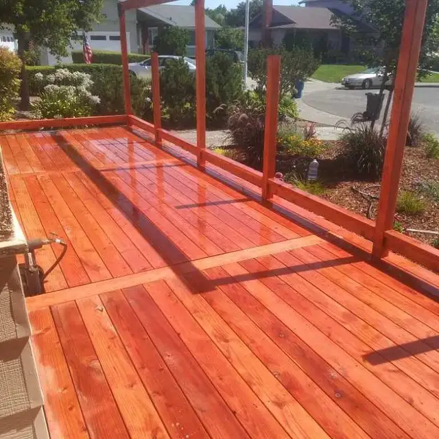 Freshly built redwood deck with pergola posts and Simpson hardware under construction at a Petaluma home