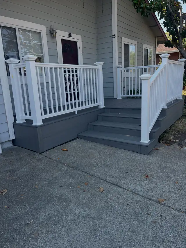 New gray composite entry stairs with white vinyl railing leading to a Rohnert Park home's front door