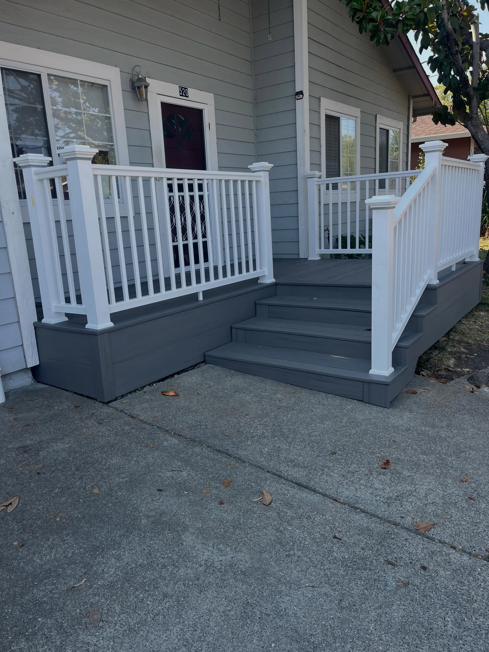 New gray composite entry stairs with white vinyl railing leading to a Rohnert Park home's front door