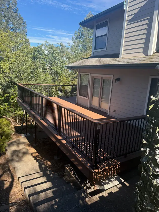 Elevated composite deck with dark metal railing on the back of a two-story Santa Rosa home