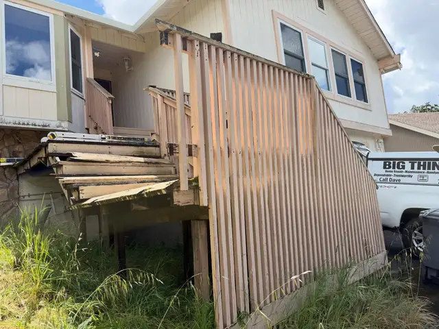 Deteriorated wood exterior staircase and deck platform being demolished at a Santa Rosa home entrance