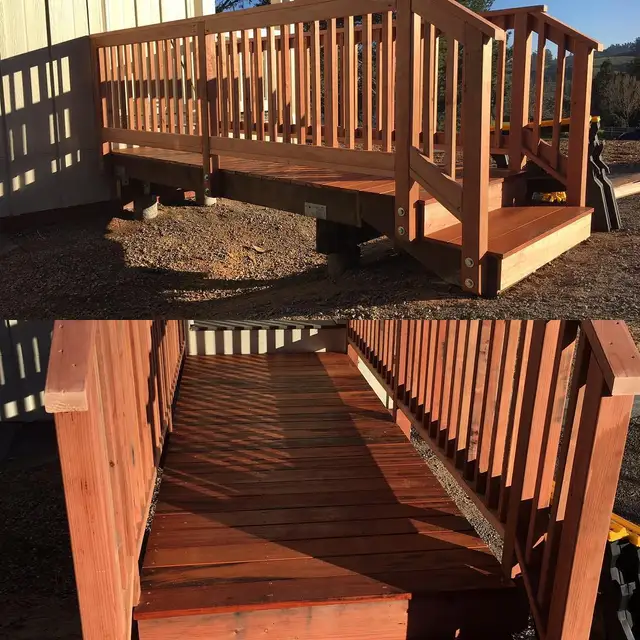 Elevated redwood and tiger wood walkway with railing and steps on concrete footings, Sebastopol home