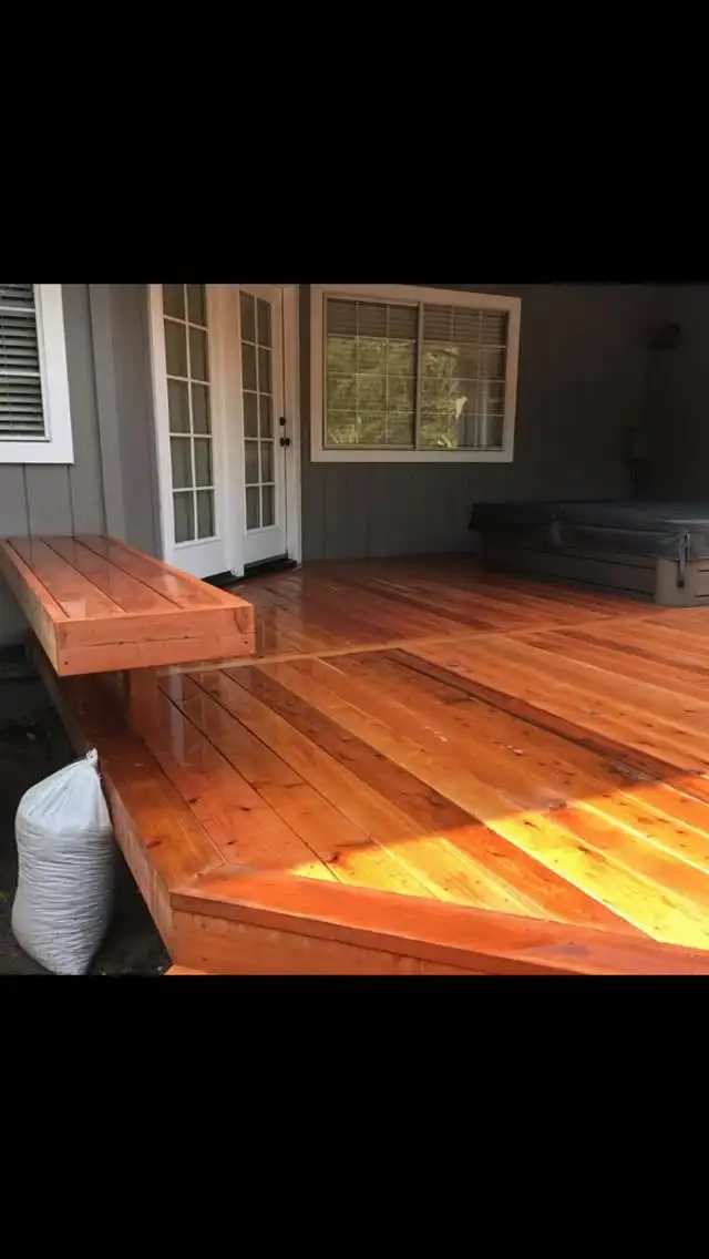Finished redwood deck in Sonoma with diagonal decking, built-in bench, and French door access near a hot tub